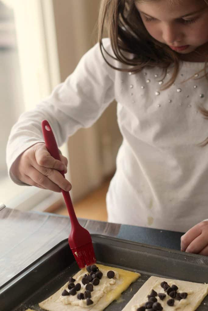 Child helping to make Chocolate Chip Cheese Danishes