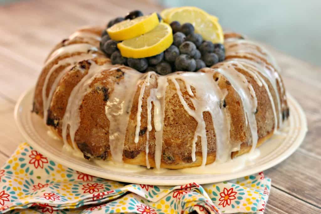 Blueberry Yogurt Cake garnished with fresh blueberries and lemons