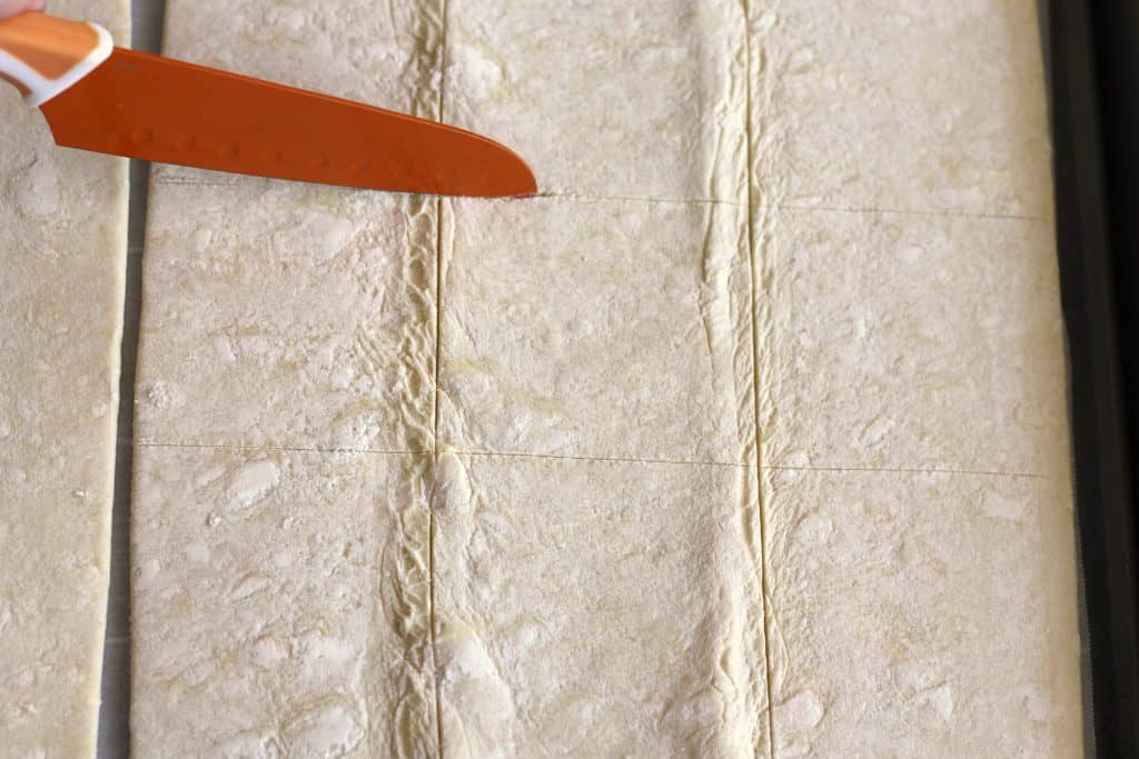 Cutting puff pastry for Cuban Guava Pastries - Pastelitos de Guayaba y Queso
