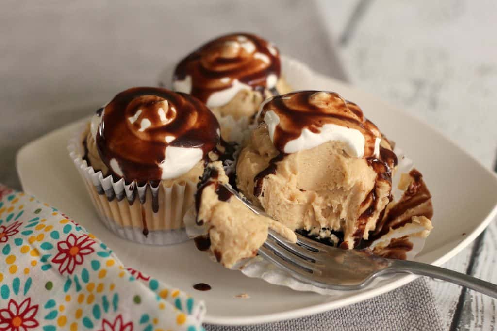 No Bake Mini Peanut Butter Cheesecakes on a plate being eaten