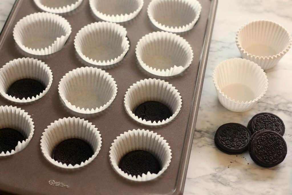 Lining muffin tins for No Bake Mini Peanut Butter Cheesecakes