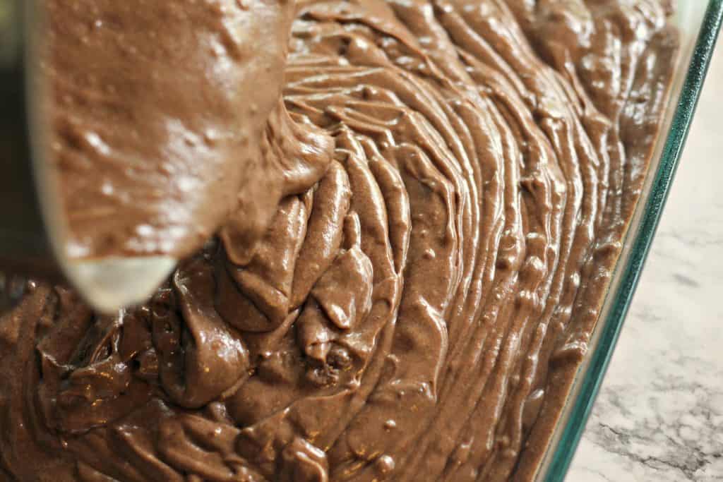 Pouring Sour Cream Chocolate Cake batter into a Pyrex dish