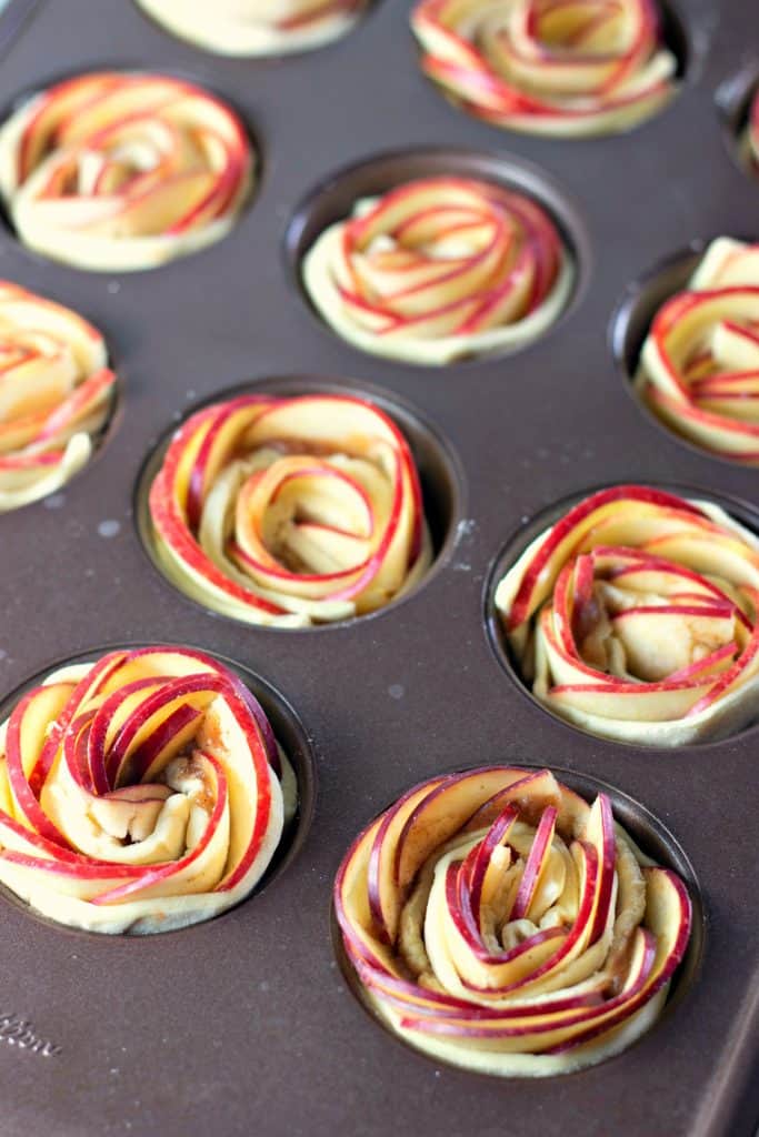 A Wilton muffin tin filled with Caramel Apple Rose Tarts ready to be baked