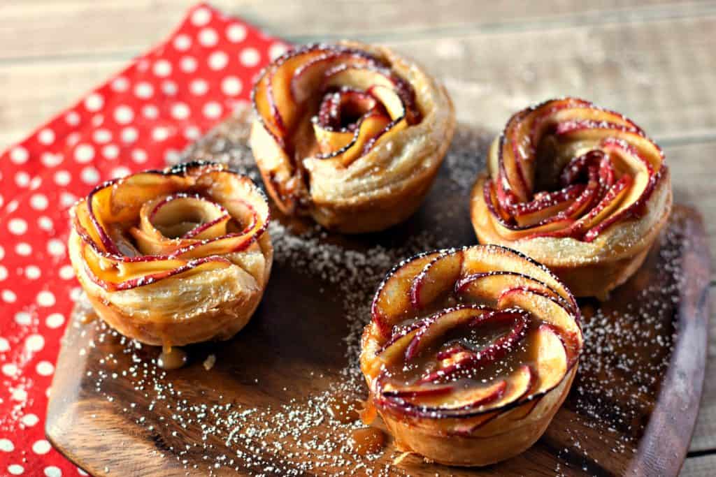 Caramel Apple Rose Tarts dusted with powdered sugar