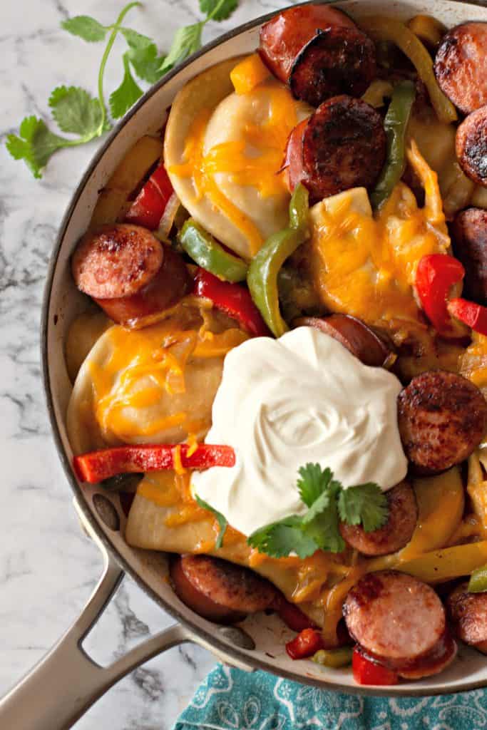 Pierogi Skillet | This delicious Pierogi Skillet combines the classic favorite potato and cheddar pierogi with freshly sautéed bell peppers and onions along with perfectly browned medallions of kielbasa. All the best flavors in one pan... dinner is served! #Pierogi #Pierogies #pierogiskillet #SkilletDinner #Dinner #DinnerRecipe #Supper #SupperRecipe #Kielbasa 
