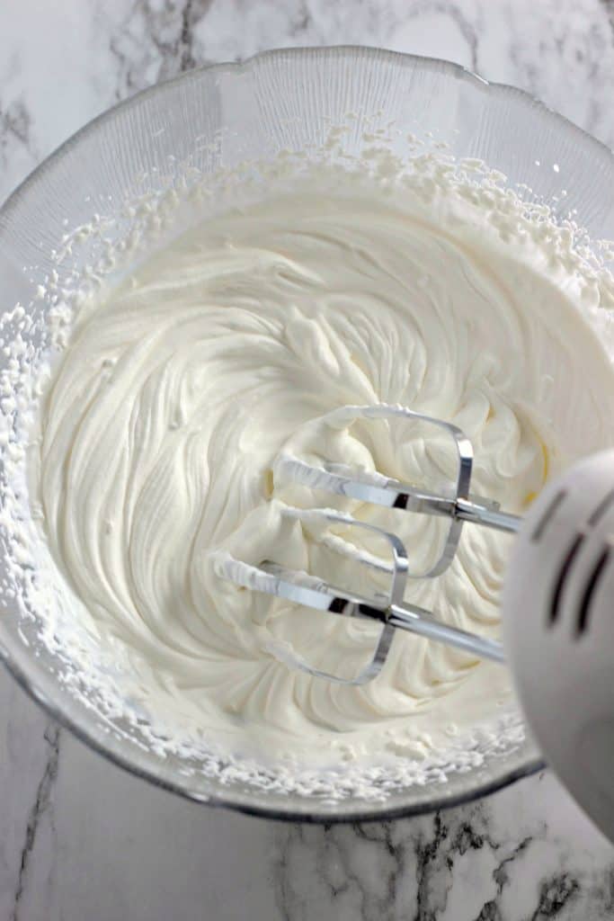 Whipping heavy whipping cream to make Keto Strawberry Fluff Dessert