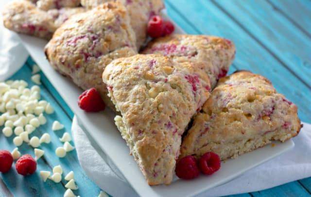 Raspberry White Chocolate Scones on a teal blue table