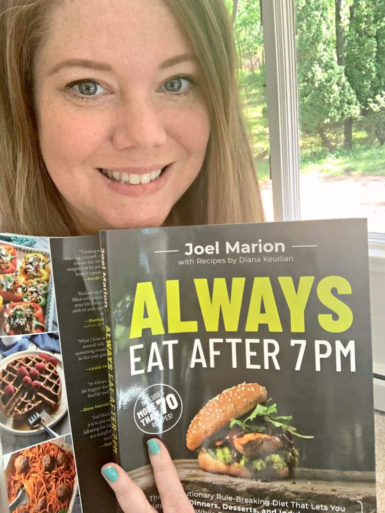 Carissa Shaw holding a copy of Always Eat After 7PM