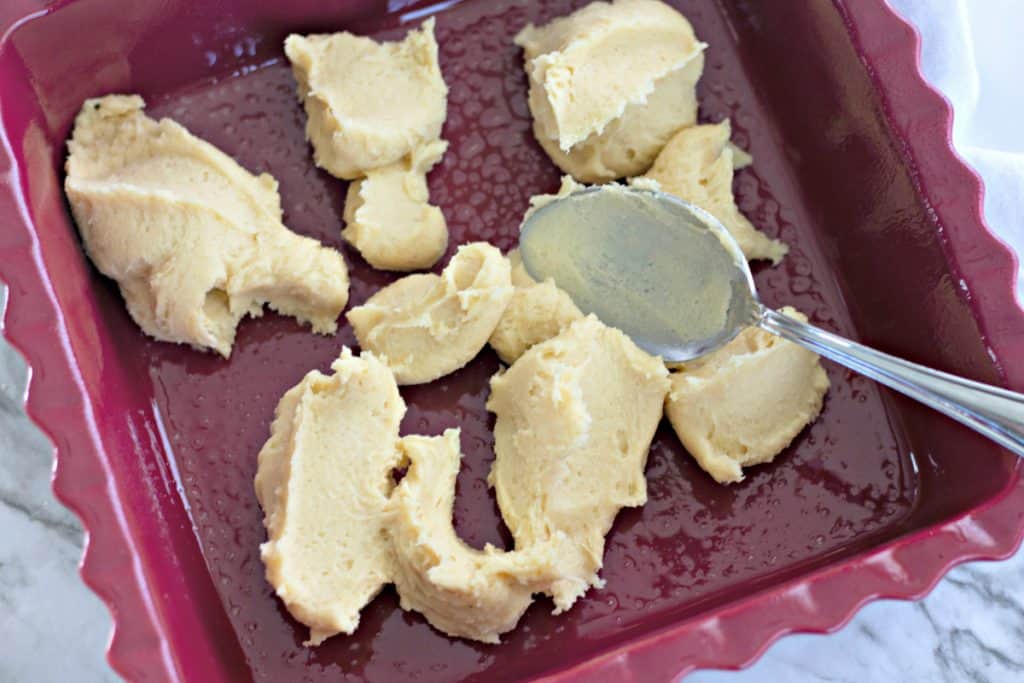 dollops of cookie dough in a square baking dish