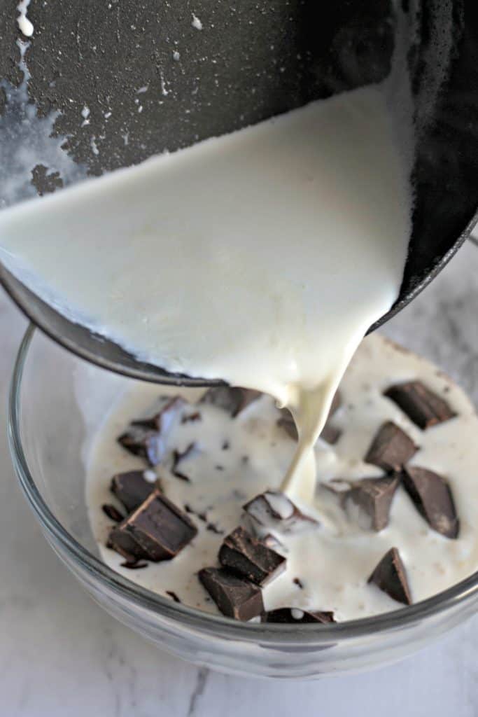 pouring hot cream into a bowl of chocolate