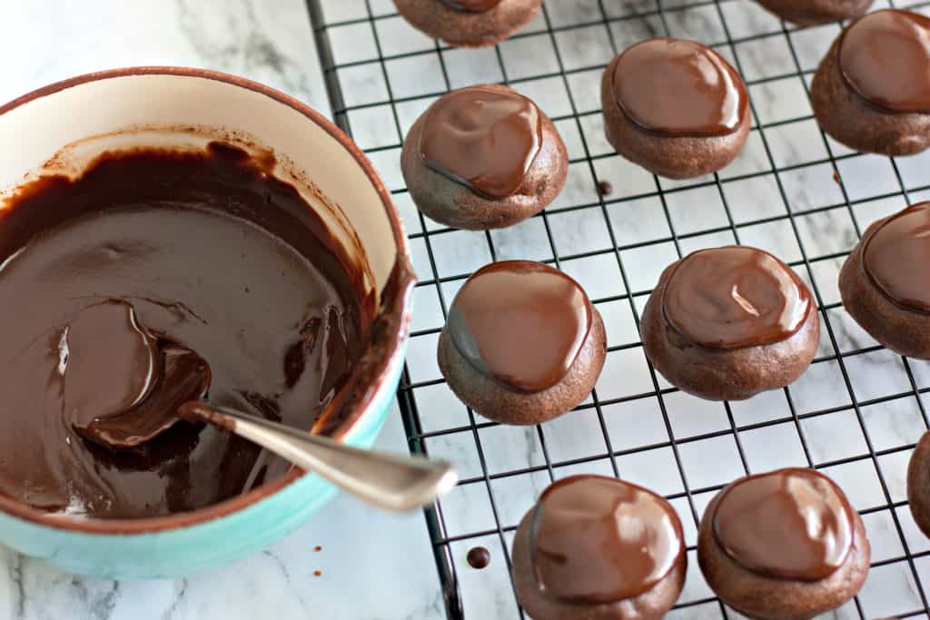 frosting the cookies with chocolate ganache