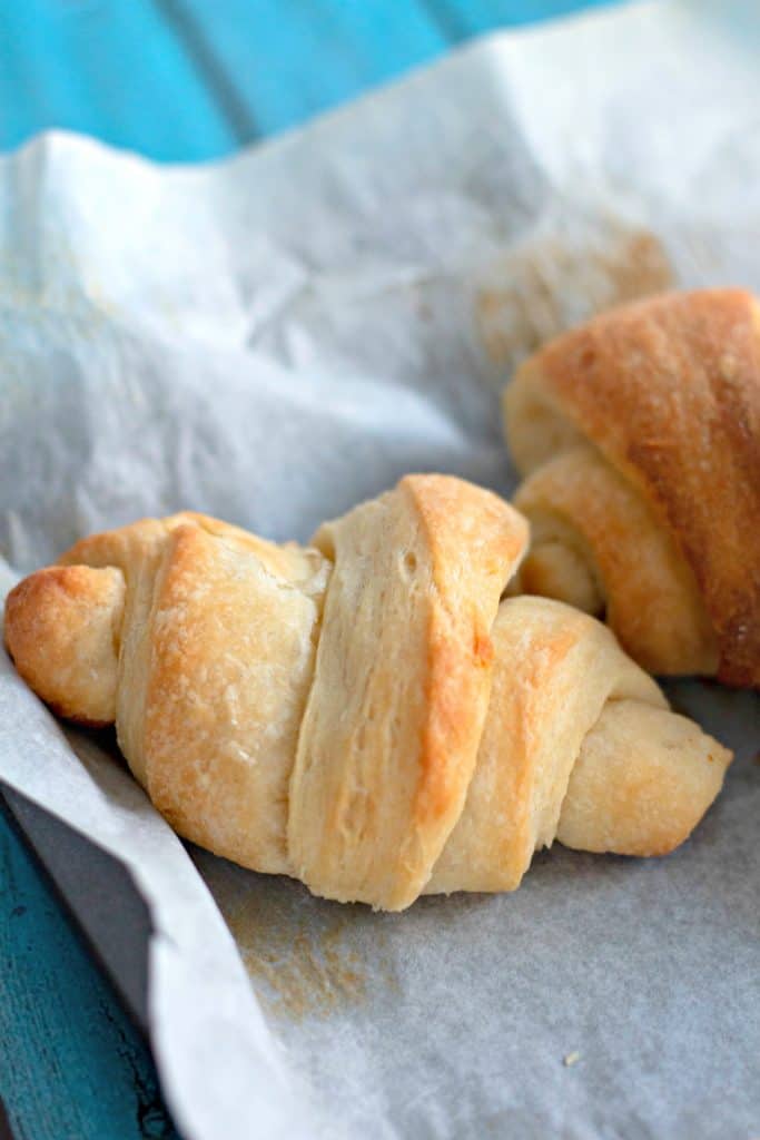 one perfect crescent roll on parchment paper