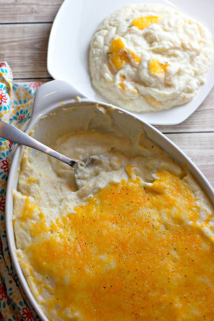Keto Cheesy Mashed Cauliflower in a casserole dish and on a plate