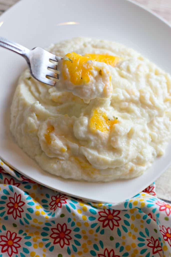 Keto Cheesy Mashed Cauliflower on a plate with a fork