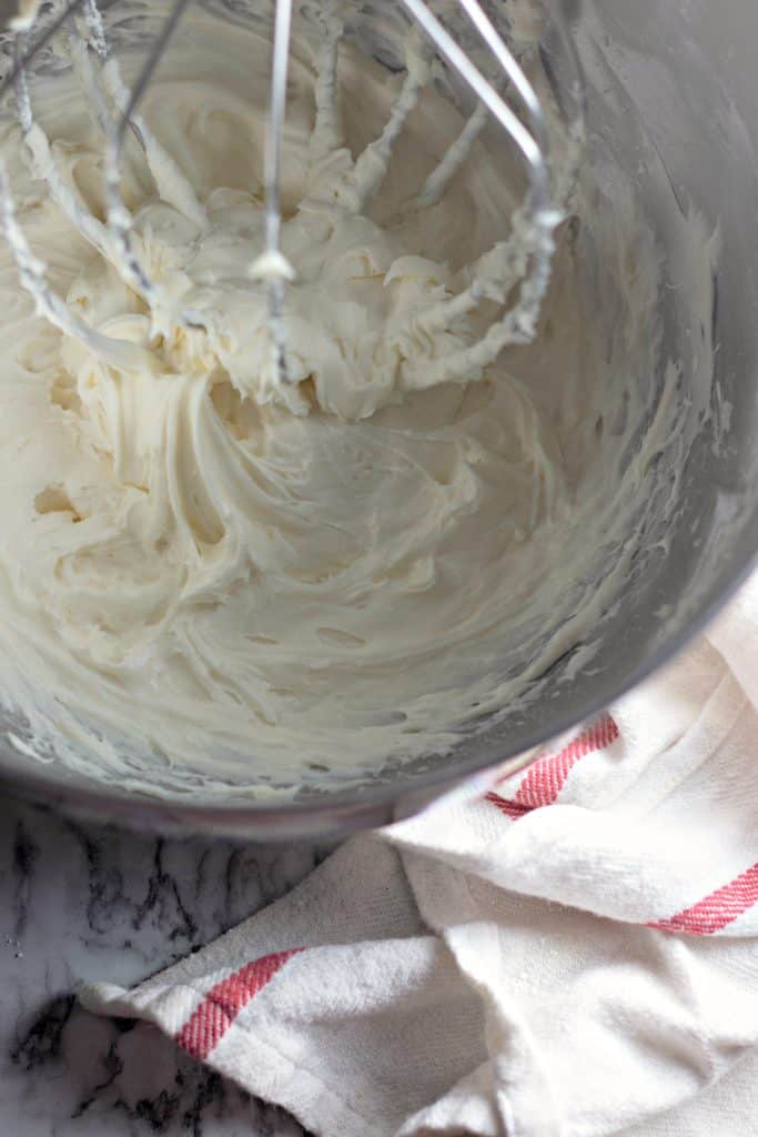 beating ingredients together for cream cheese frosting in a KitchenAid mixer