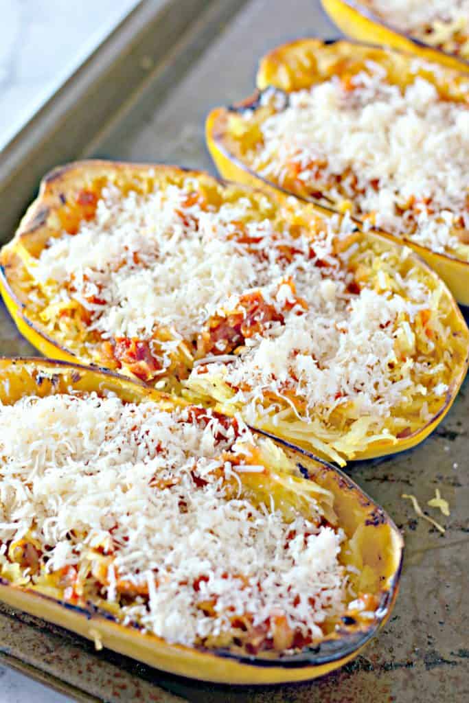 sprinkling grated parmesan cheese onto the squash