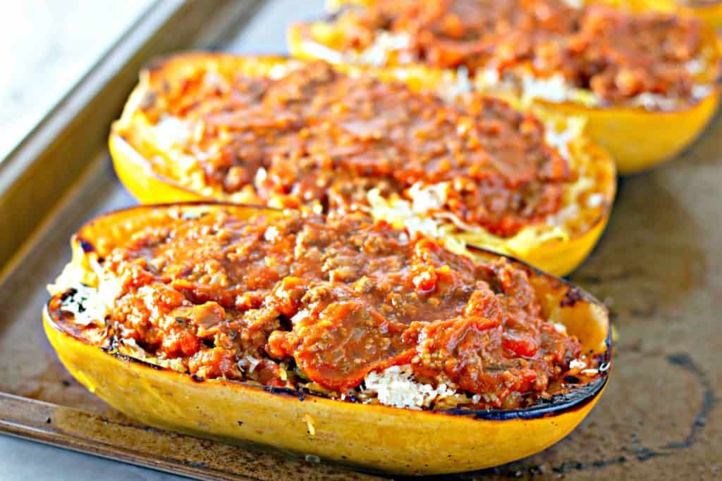 scooping the meat sauce onto the spaghetti squash