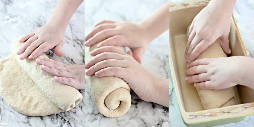 child forming bread dough into a load.