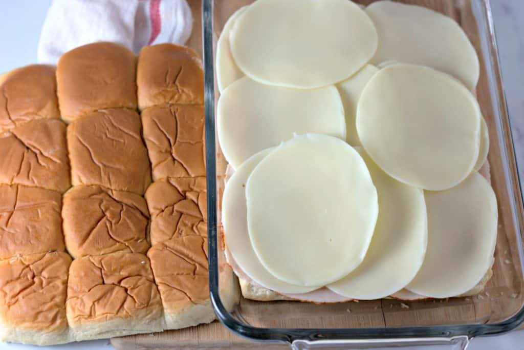 adding a layer of provolone cheese slices.