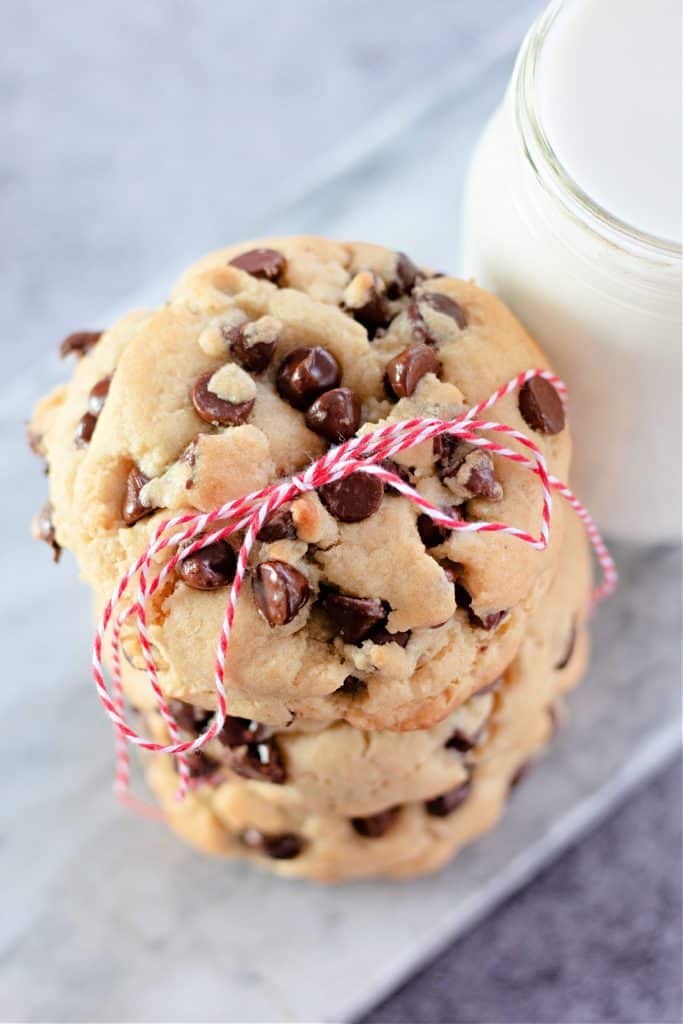 a stack of Bakery Style Giant Chocolate Chip Cookies tied up with a red and white string.