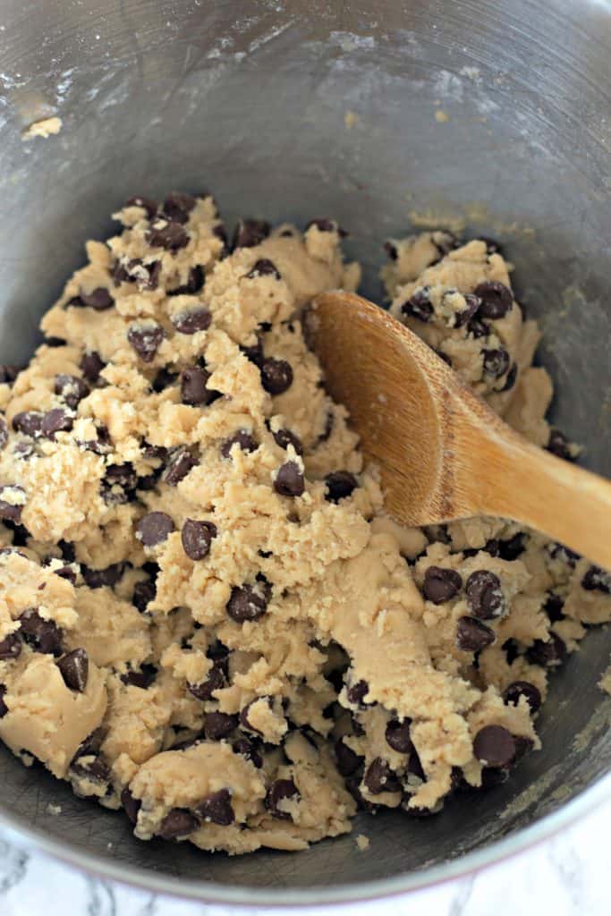 chocolate chip cookie dough in a metal mixing bowl.
